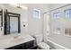 Bright bathroom featuring a tiled shower-tub combination and sleek black vanity at 7601 E Roosevelt St # 1007, Scottsdale, AZ 85257