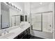 Well-lit bathroom featuring a double vanity with modern fixtures and glass shower enclosure at 7601 E Roosevelt St # 1007, Scottsdale, AZ 85257