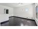 Spacious bedroom featuring a ceiling fan, dark wood floors and trim, and multiple windows at 7601 E Roosevelt St # 1007, Scottsdale, AZ 85257