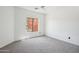 Bright bedroom with carpeting, a ceiling fan, and a large window providing natural light at 7601 E Roosevelt St # 1007, Scottsdale, AZ 85257