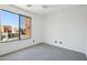 Bedroom featuring carpeting and a bright sunny window overlooking neighboring properties at 7601 E Roosevelt St # 1007, Scottsdale, AZ 85257