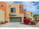 Modern townhome displaying Southwest architecture with a two-car garage and colorful desert landscaping at 7601 E Roosevelt St # 1007, Scottsdale, AZ 85257