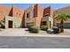 A contemporary townhouse showing the front yard landscaping, a private drive, and one-car garage at 7601 E Roosevelt St # 1007, Scottsdale, AZ 85257