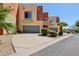 A modern townhome featuring a private drive, front yard landscaping, and a one car garage at 7601 E Roosevelt St # 1007, Scottsdale, AZ 85257