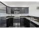A kitchen with stainless steel appliances, dark cabinets, and granite countertops at 7601 E Roosevelt St # 1007, Scottsdale, AZ 85257