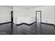 An open concept living area with dark wood flooring and black door frames at 7601 E Roosevelt St # 1007, Scottsdale, AZ 85257