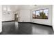 Spacious, minimalist living room with dark hardwood floors and expansive windows offering bright, natural light at 7601 E Roosevelt St # 1007, Scottsdale, AZ 85257