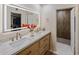 Bright bathroom featuring double sinks, quartz countertop, sleek vanity, and a decorative accent wall shower at 8083 E Via Del Valle --, Scottsdale, AZ 85258