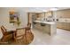 Bright kitchen with modern cabinets, a large island with bar seating, and a sunlit dining area at 8083 E Via Del Valle --, Scottsdale, AZ 85258