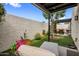 Cozy patio featuring artificial grass, a stucco wall, and an outdoor seating area at 8083 E Via Del Valle --, Scottsdale, AZ 85258