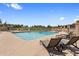 Relaxing community pool area with lounge chairs and a view of the serene lake at 8083 E Via Del Valle --, Scottsdale, AZ 85258