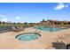 Community pool and hot tub with comfortable lounge chairs overlooking the lake at 8083 E Via Del Valle --, Scottsdale, AZ 85258