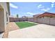 Well-maintained backyard featuring gravel, concrete patio and synthetic grass at 809 W Kingman Dr, Casa Grande, AZ 85122