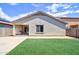 Backyard with a covered patio, synthetic grass, gravel and concrete at 809 W Kingman Dr, Casa Grande, AZ 85122