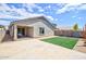 Spacious backyard with a covered patio and artificial grass at 809 W Kingman Dr, Casa Grande, AZ 85122