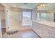 Bathroom with a shower, a bathtub, a double vanity, and a view from the window at 809 W Kingman Dr, Casa Grande, AZ 85122