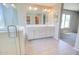Bright primary bathroom with double vanity, shower, bathtub and lots of natural light at 809 W Kingman Dr, Casa Grande, AZ 85122