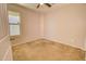 Bright bedroom with ceiling fan and large window that provides plenty of natural light and airflow at 809 W Kingman Dr, Casa Grande, AZ 85122