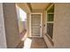 Close-up of the front door with a screen door and textured columns on either side at 809 W Kingman Dr, Casa Grande, AZ 85122
