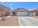 Charming single-story home with a two-car garage, concrete driveway, and desert landscaping at 809 W Kingman Dr, Casa Grande, AZ 85122