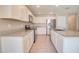 Bright kitchen with white cabinets, granite countertops, stainless steel appliances, and wood-look tile flooring at 809 W Kingman Dr, Casa Grande, AZ 85122