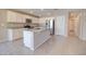 Bright kitchen with white cabinets, granite countertops, stainless steel appliances, and wood-look tile flooring at 809 W Kingman Dr, Casa Grande, AZ 85122