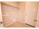 A practical laundry room featuring a shelf, connections, and a bright white door at 809 W Kingman Dr, Casa Grande, AZ 85122
