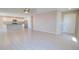 Spacious living room with wood-look tile flooring open to the kitchen with a white door at 809 W Kingman Dr, Casa Grande, AZ 85122