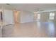 Open-concept living room with wood-look tile flooring and views of the backyard at 809 W Kingman Dr, Casa Grande, AZ 85122