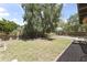 Large backyard with a patio area, mature trees, and ample space for outdoor activities at 8234 W Sweetwater Ave, Peoria, AZ 85381