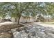 Expansive backyard with a covered patio, mature trees, and a spacious concrete area at 8234 W Sweetwater Ave, Peoria, AZ 85381
