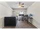 Comfortable bedroom with a ceiling fan, large window, and neutral carpeting at 8234 W Sweetwater Ave, Peoria, AZ 85381