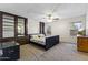 Serene bedroom boasts built-in storage, a ceiling fan, and a sunlit window at 8234 W Sweetwater Ave, Peoria, AZ 85381
