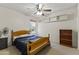 Cozy bedroom features a ceiling fan, built-in shelves, and a window for natural light at 8234 W Sweetwater Ave, Peoria, AZ 85381
