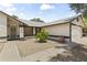 Well-maintained house exterior features a charming front entrance, decorative rock landscaping, and a two-car garage at 8234 W Sweetwater Ave, Peoria, AZ 85381