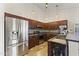 Modern kitchen with stainless steel appliances, dark wood cabinets, and a view of the backyard at 8234 W Sweetwater Ave, Peoria, AZ 85381