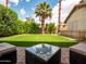 Lush backyard featuring artificial grass, desert landscaping, and comfortable seating area at 936 E Gila Ln, Chandler, AZ 85225