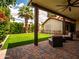 Relaxing back yard area featuring a covered patio, pavers, and a well-maintained artificial grass lawn at 936 E Gila Ln, Chandler, AZ 85225