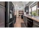 Stylish kitchen featuring stainless steel appliances, sleek countertops, and ample cabinet space plus laundry area at 936 E Gila Ln, Chandler, AZ 85225