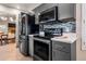 Modern kitchen boasting stainless steel appliances, mosaic backsplash, grey cabinets and a view to the dining room at 936 E Gila Ln, Chandler, AZ 85225