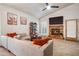 Open living room with large sectional sofa, brick fireplace, and modern decor, creating a comfortable and stylish space at 936 E Gila Ln, Chandler, AZ 85225