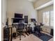 Bright office featuring multiple monitors, black desk, adjustable chair and exercise bike, perfect for working from home at 936 E Gila Ln, Chandler, AZ 85225