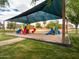 Community playground with covered picnic tables and mature trees at 936 E Gila Ln, Chandler, AZ 85225
