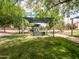 Neighborhood playground with shade canopies, grass and mature trees at 936 E Gila Ln, Chandler, AZ 85225