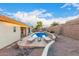A stunning backyard pool area with stone pavers, lounge chairs, and privacy fencing at 9548 E Grandview St, Mesa, AZ 85207
