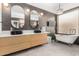 Luxurious bathroom featuring double sinks, a soaking tub, and modern finishes at 9548 E Grandview St, Mesa, AZ 85207