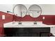 Stylish bathroom featuring a double vanity with round mirrors, black fixtures, and modern accents at 9548 E Grandview St, Mesa, AZ 85207