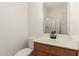 Clean bathroom featuring a wood vanity, marble countertop, and shower at 9548 E Grandview St, Mesa, AZ 85207