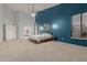 Spacious bedroom featuring high ceilings, a fan, stylish lighting, and large windows at 9548 E Grandview St, Mesa, AZ 85207