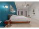 Bright bedroom with a modern bed, a side table, neutral carpet, and a large window at 9548 E Grandview St, Mesa, AZ 85207